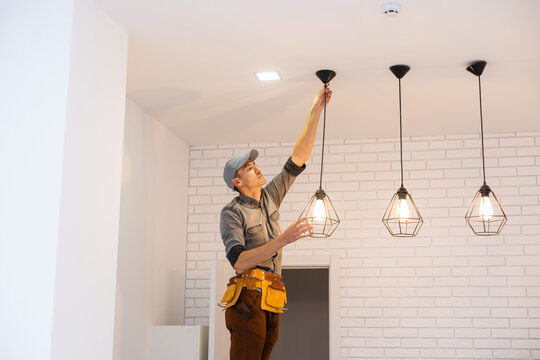 What should I look for when hiring an electrician for light installation?